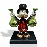 Billionaire McDuck™ collectible figurine from Atelier Home Gallery showing Donald Duck in a wealthy pose with gold accents.